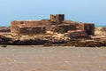 View of the small island with ruins of the ancient fortress near the Atlantic coast in the Essaouira on a sunny summer day. Royalty Free Stock Photo