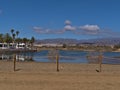 View of small lagoon La Charca in Meloneras, part of Maspalomas, southern Gran Canaria, Spain with fence in front. Royalty Free Stock Photo