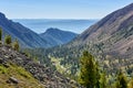 View of small mountain valley from slope of mountain