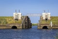 View of a small and old lock on a river flowing into the North Sea Royalty Free Stock Photo