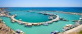 View on small port and fishing boats parked near pier of Vlychada town on Santorini island Royalty Free Stock Photo