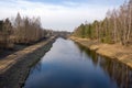 View of a small river with a bridge in spring. Channel of the Vileyka-Minsk water system for the transfer of water flow