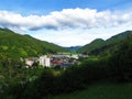 View of small town of Zelezniki in Selska dolina in Gorenjska region of Slovenia surrounded by forest covered hills