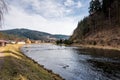 View of small village near the river, with typical architecture and small church. Forest and trees in the background. Countryside Royalty Free Stock Photo