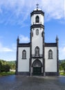 View of small white and gray church of Sao Nicolau at the village of Sete Cidades on the island of Sao Miguel, Azores Royalty Free Stock Photo