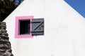 View of a small window with pink square on a white wall Royalty Free Stock Photo