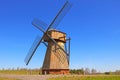 View of a small wooden windmill against a blue sky background Royalty Free Stock Photo