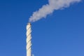 View of smoke coming out of chimney against blue sky. Ecology and greenhouse effect concept. Royalty Free Stock Photo