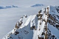 View of snow capped peaks above clouds