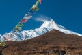 View of snow covered Mount Manaslu 8 156 meters with prayer flags and forest. Himalayas, Manaslu Gorkha District, Nepal Royalty Free Stock Photo