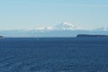 View on snow covered mountain from merchant vessel approaching Vancouver, British Columbia from Pacific ocean.