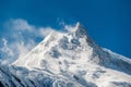 View of snow covered peak of Mount Manaslu 8 156 meters with clouds in Himalayas, Detail of snowy peak. Royalty Free Stock Photo