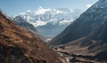View of snow covered range of Mount Manaslu and valley on the way to pass 8 156 meters with clouds in Himalayas, sunny day Royalty Free Stock Photo
