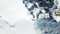 View of the snow top of the mountain from above. Group of climbers at the peak.