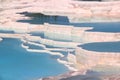 View of snow-white travertines filled with blue water in Pamukkale, Turkey Royalty Free Stock Photo