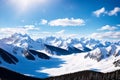 a view of snowcapped mountains against a cloudy sky.