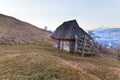 View of snowcovered mountain Hoverla from the pasture with n old wooden house