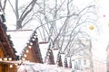 view of snowed roofs of christmas village at city square