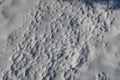 View of a snowy meadow with long snowy human footprints. Drone view creates a pattern of dispersion and paths of human footsteps o