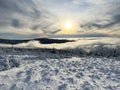 View of snowy mountain ridges in the clouds, Giant Mountains, Czech Republic Royalty Free Stock Photo