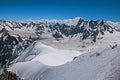 View of snowy peaks and mountaineers from the Aiguille du Midi in French Alps Royalty Free Stock Photo