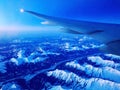 A view of snowy peaks from an airplane