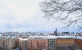 View of the snowy rooftops of the colourful Stockholm skyline, taken from a local park, Stockholm, Sweden.