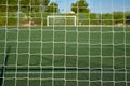 view of a soccer field behind the net of a goal Royalty Free Stock Photo