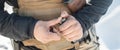 View of soldier hands load gun bullets into cartridge clip