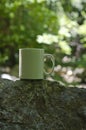 A solo blank white coffee mug on the stones Royalty Free Stock Photo