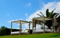 View of some beds sunloungers and palm trees on a green grass in a beach club of Tenerife,Canary Islands,Spain.