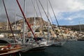 View of some boats and city hill with lots of houses on it at the Calymnos city harbor, in Calymnos Island