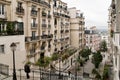 A view of some historical buildings and a little view of Paris, through the buildings in Monmarte Royalty Free Stock Photo