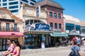 View of some stores on the Atlantic City Boardwalk. The facade of the famous James` Salt Water Taffy store is seen with tourists