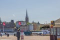 View of some tourists on Stockholm City Center Pier with Historic Buildings on pale cloudless blue summer sky background. Royalty Free Stock Photo