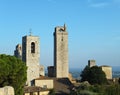 View of some of the towers of San Gimignano, Italy, standing tall against blue sky