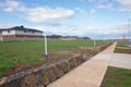 View of some vacant lot of lands and pedestrian walkway with some modern new Australian homes/houses in the distance. Royalty Free Stock Photo