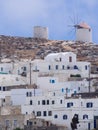 A view of some white houses of Chora of Amorgos, with the windmills above them