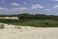 View of the Sorek River surrounded by green trees and white sand dunes Royalty Free Stock Photo