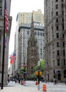 Broadway in Financial District, steeple of the Trinity Church in the center, New York, NY, USA