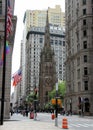 Broadway in downtown Financial District, steeple of the Trinity Church in the center, New York, NY