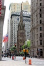 Broadway in downtown Financial District, steeple of the Trinity Church in the center, New York, NY