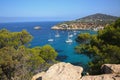 South coast of Ibiza with boats anchored in the bay. Beautiful landscape with cliffs & turquoise water. Balearic Islands, Spain