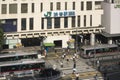 View of the southern exit of Shibuya Station, famous for its moai statue, with buses and taxis stopped at the bus terminal