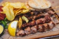 View of Souvlaki on a plate - traditional greek cuisine dish with grilled bbq chicken with french fries and tzatziki sauce served Royalty Free Stock Photo