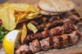 View of Souvlaki on a plate - traditional greek cuisine dish with grilled bbq chicken with french fries and tzatziki sauce served Royalty Free Stock Photo