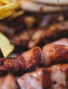 View of Souvlaki on a plate - traditional greek cuisine dish with grilled bbq chicken with french fries and tzatziki sauce served Royalty Free Stock Photo