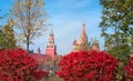 View of the Spasskaya Tower, the Moscow Kremlin and St. Basil`s Cathedral from autumnal Zaryadie park. Architecture and sights of