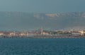 View of Split, Croatia town from a car ferry approaching for very far. Church belltower seen rising above the old buildings, Royalty Free Stock Photo