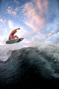 View of sports guy riding wave doing jumps and tricks on the surf style wakeboard Royalty Free Stock Photo